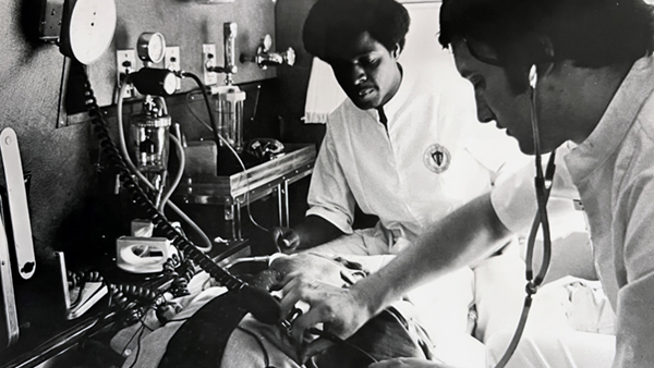 Freedom House Ambulance EMT James Kyte & Dr. Bill Raynovich doing a physical assessment on Phil Hallen. 1968-1969 (source: John Moon)